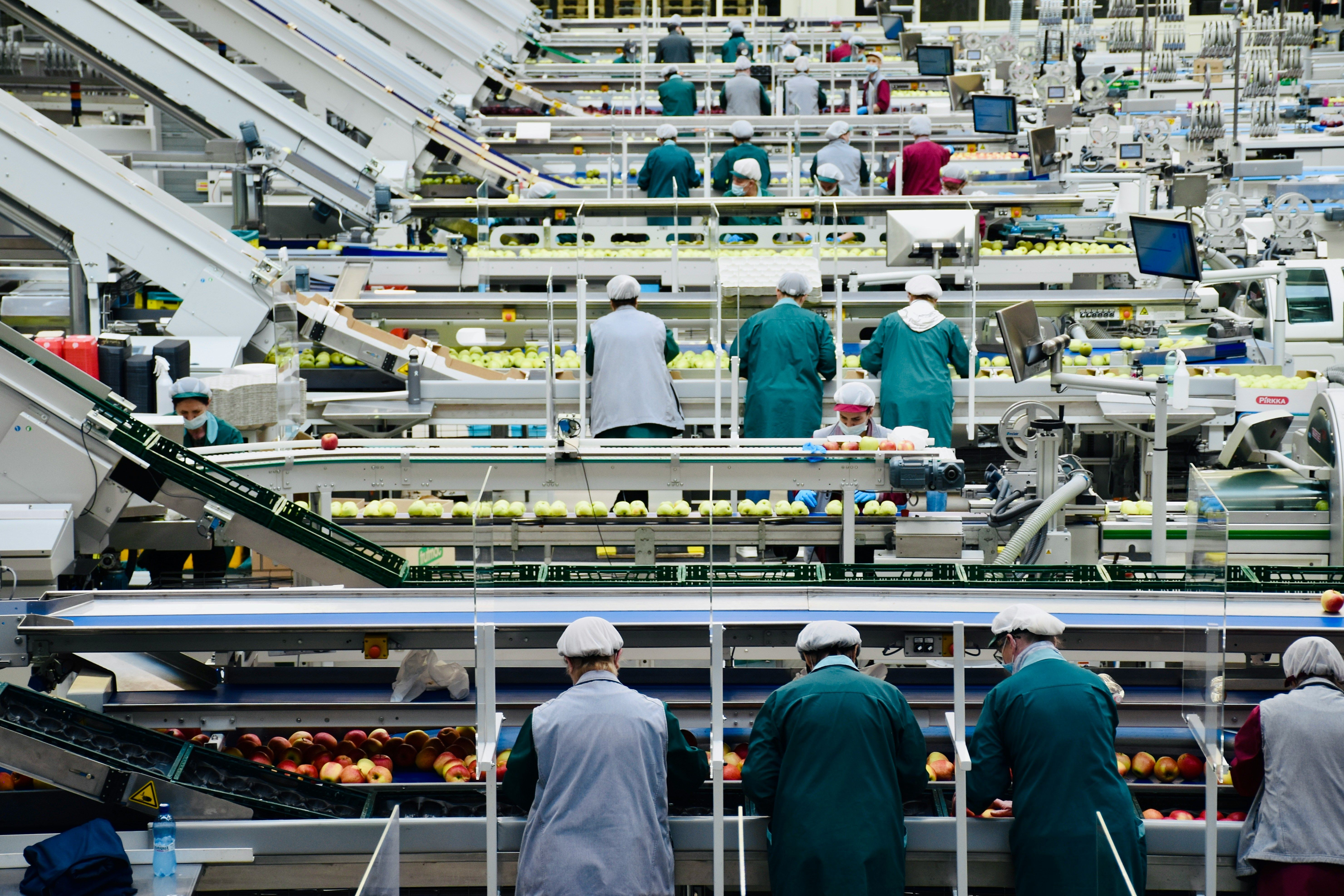 Group of men discussing work on a factory floor