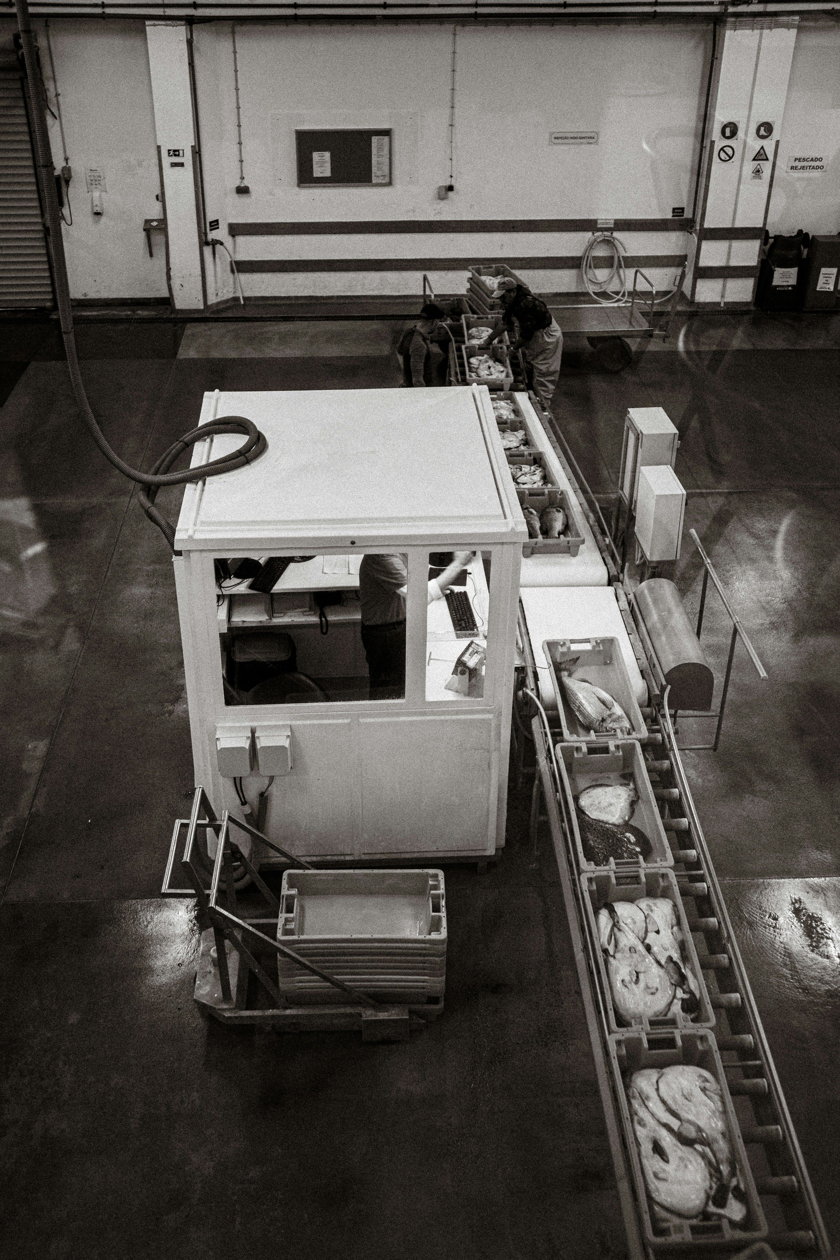 Worker operating a conveyor belt system in an industrial facility