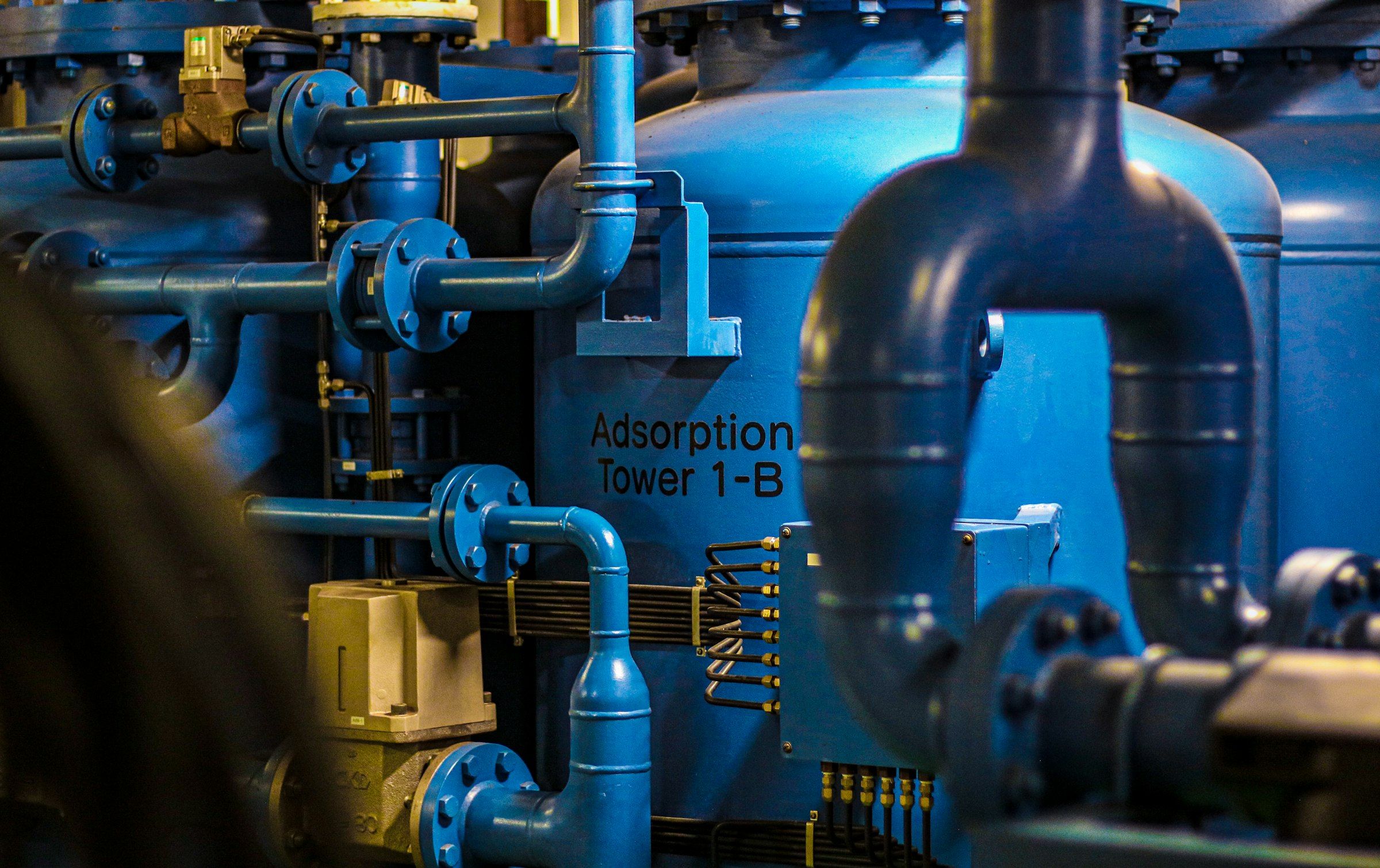 Close-up of an industrial pump and piping system on a production line