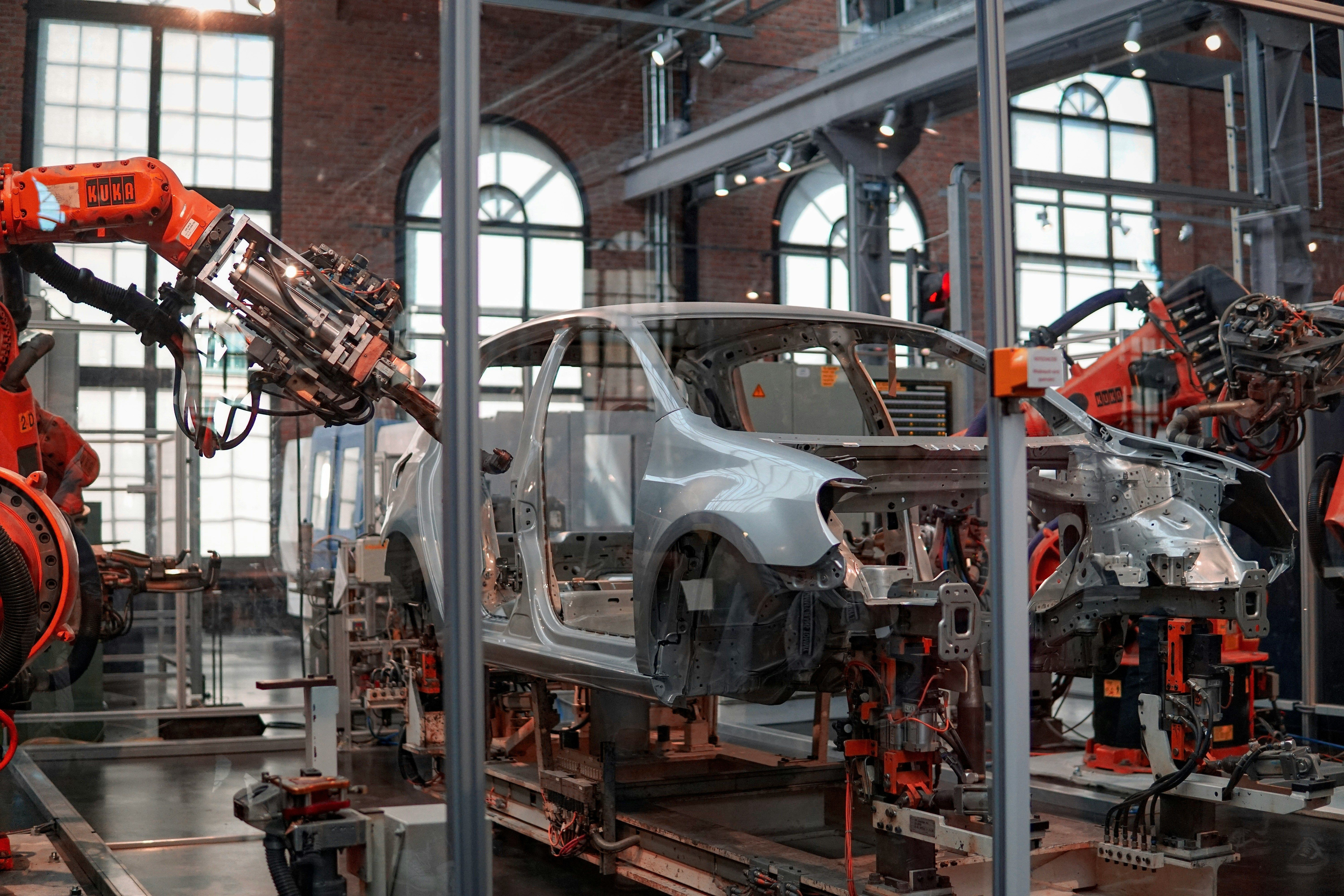 Vehicle on an automotive production line with industrial robots