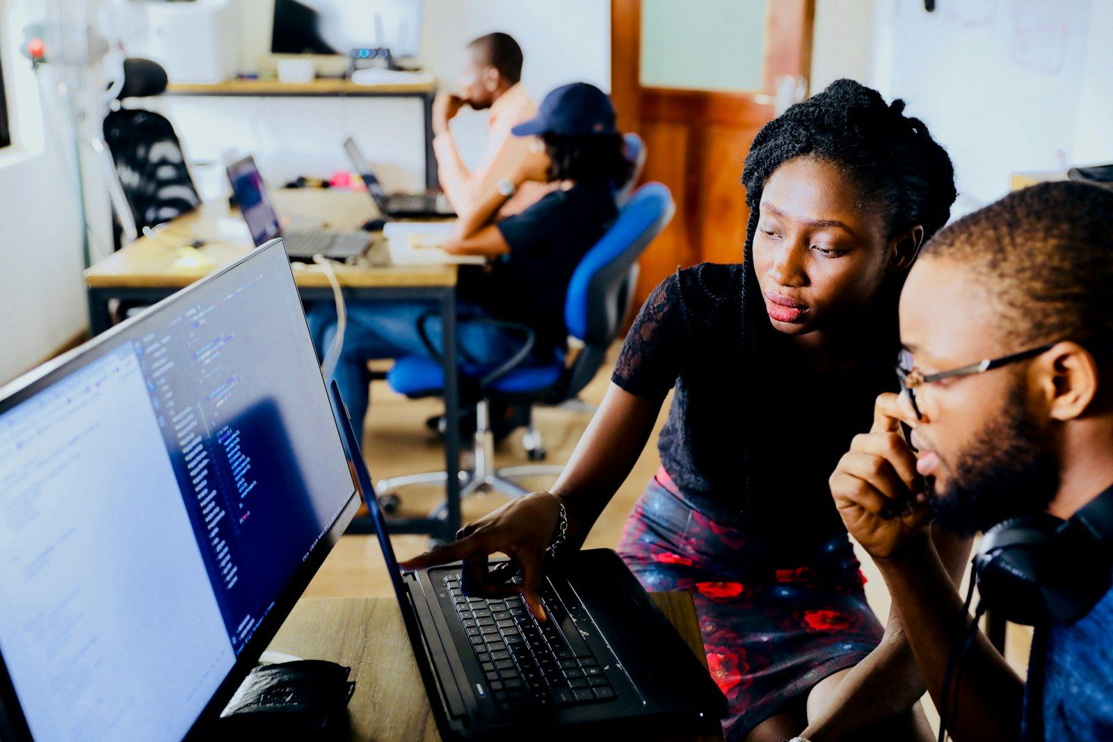 Two developers working together at a screen