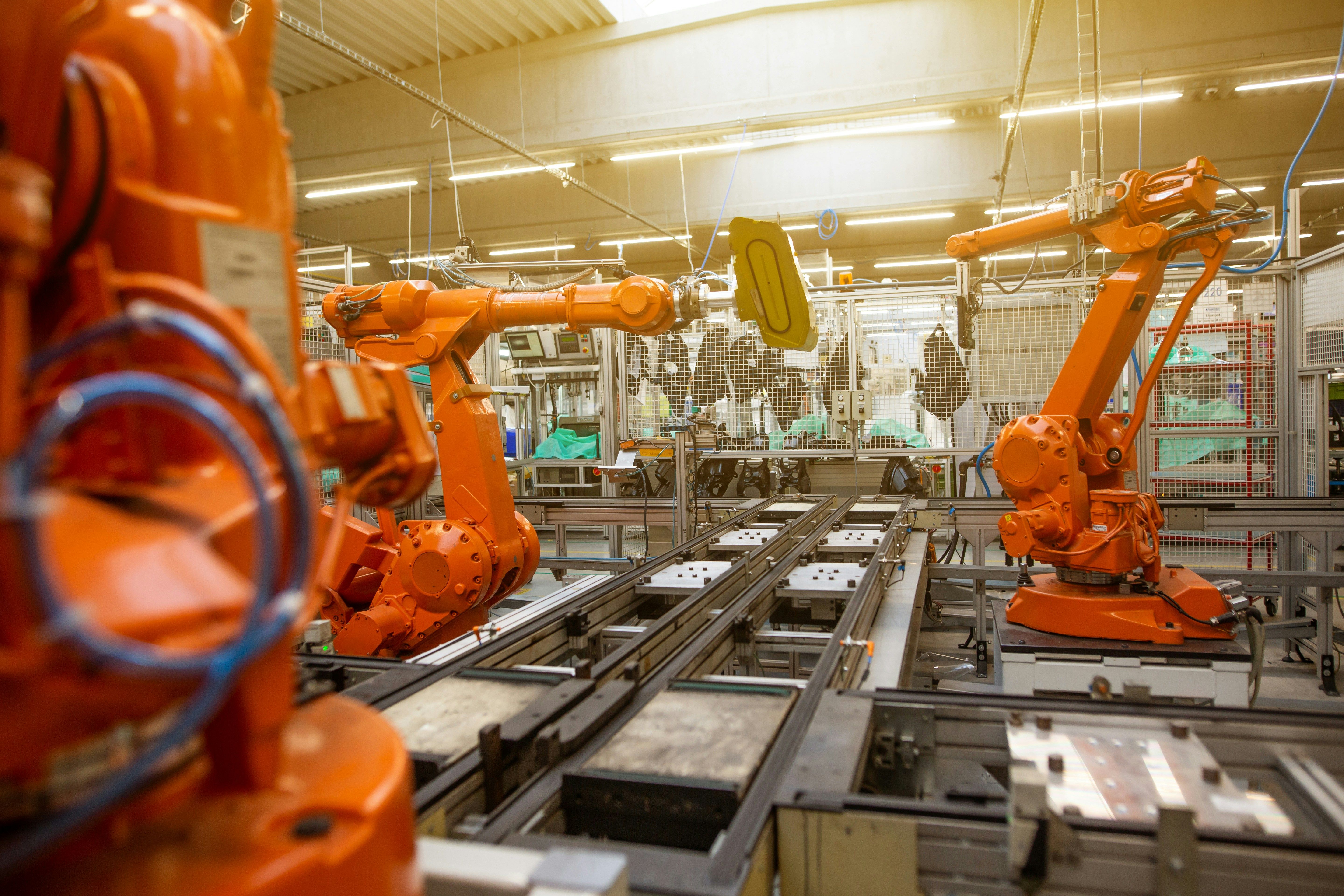 Factory floor filled with rows of orange industrial machines
