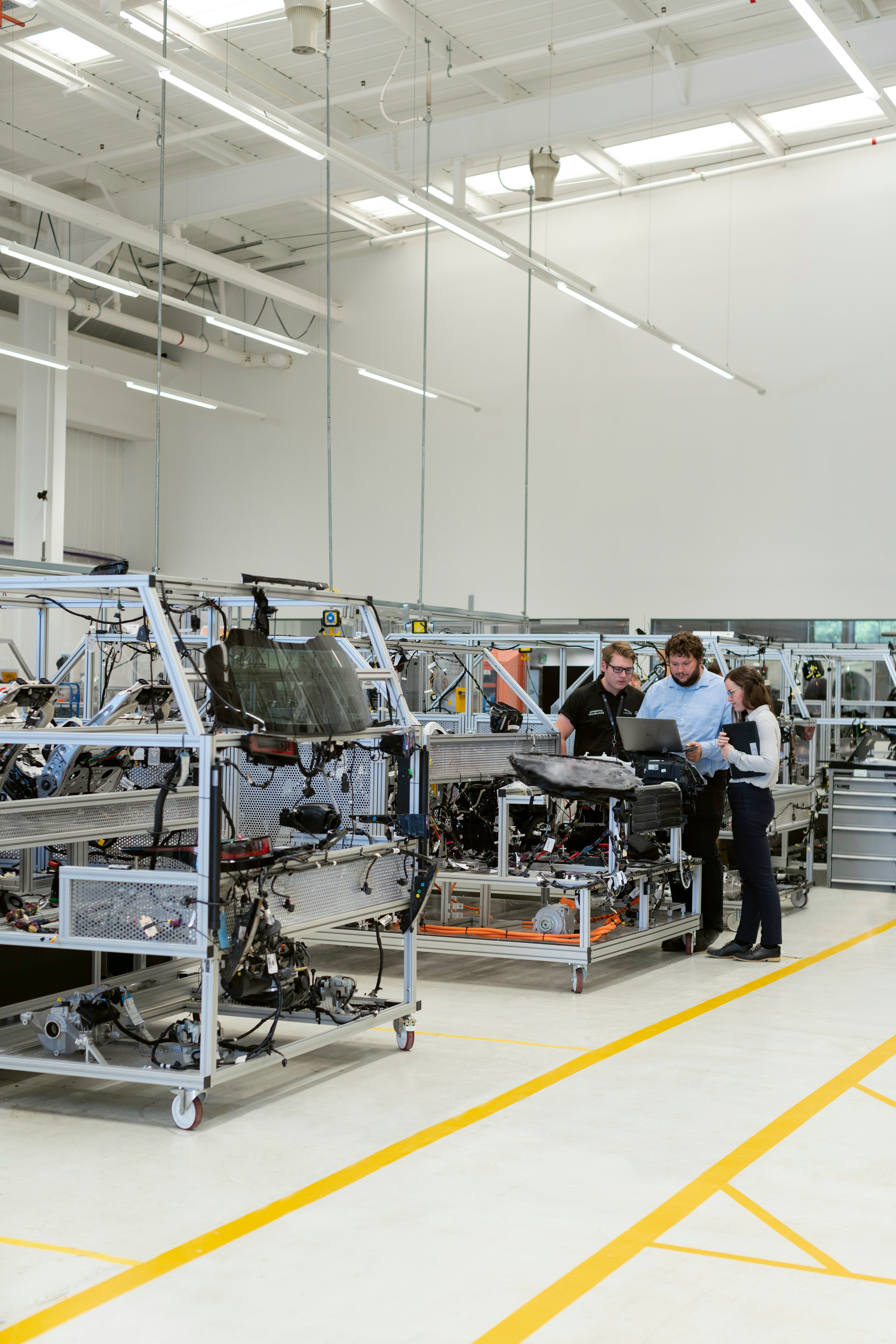 Engineers reviewing production information in an automotive factory