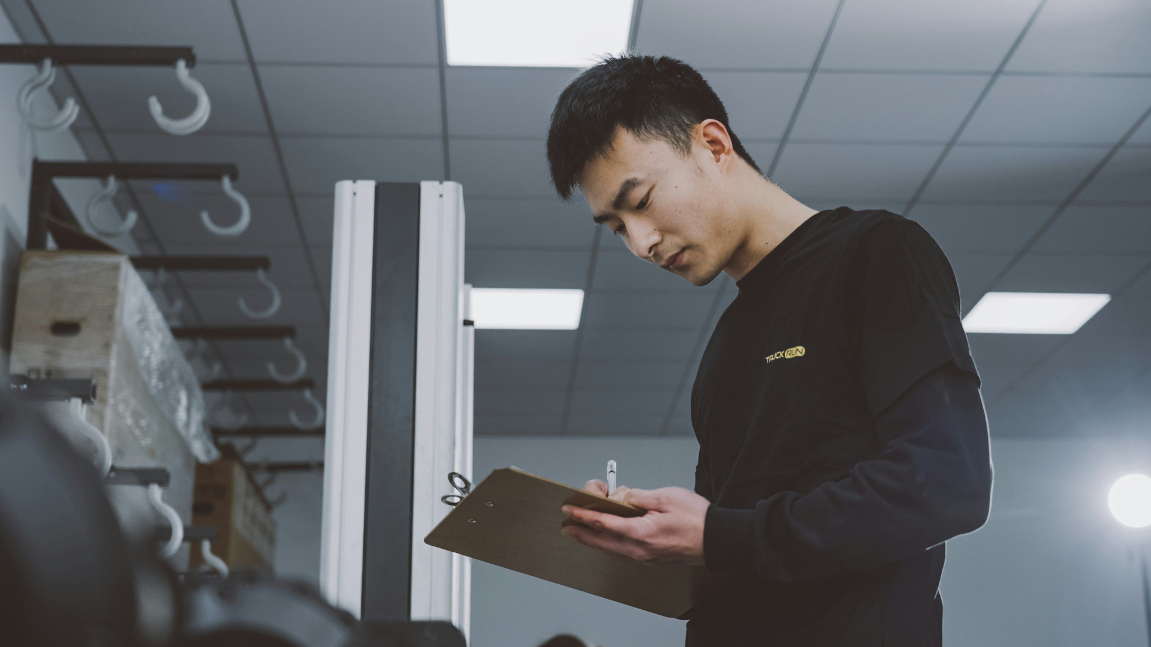 Worker holding a clipboard on the production floor