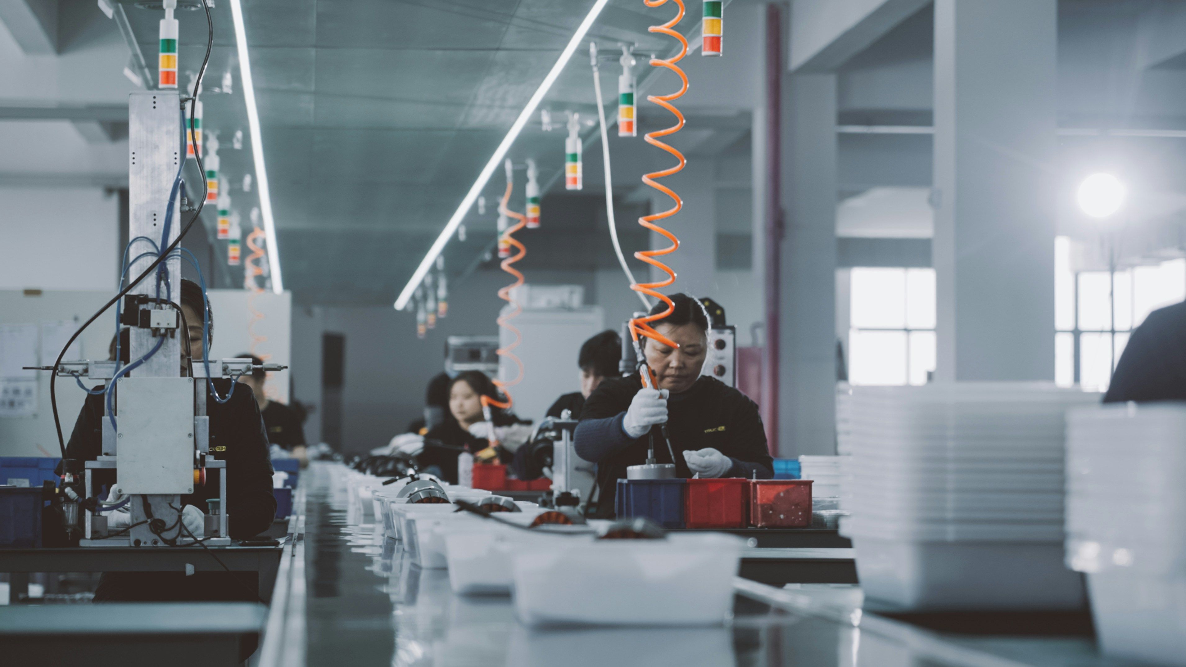 Group of people working on a factory production floor